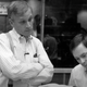 Howard Ashman stands with his arms crossed in a black-and-white image from the documentary Howard.